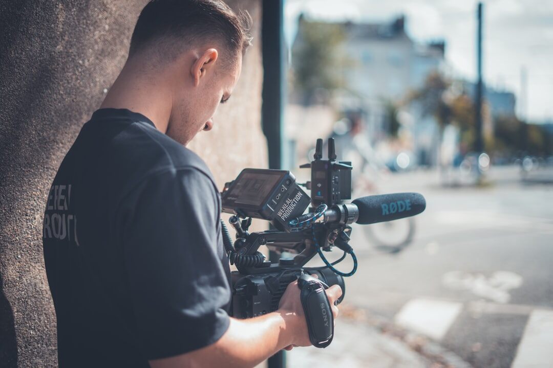 Camera operator setting up equipment on location