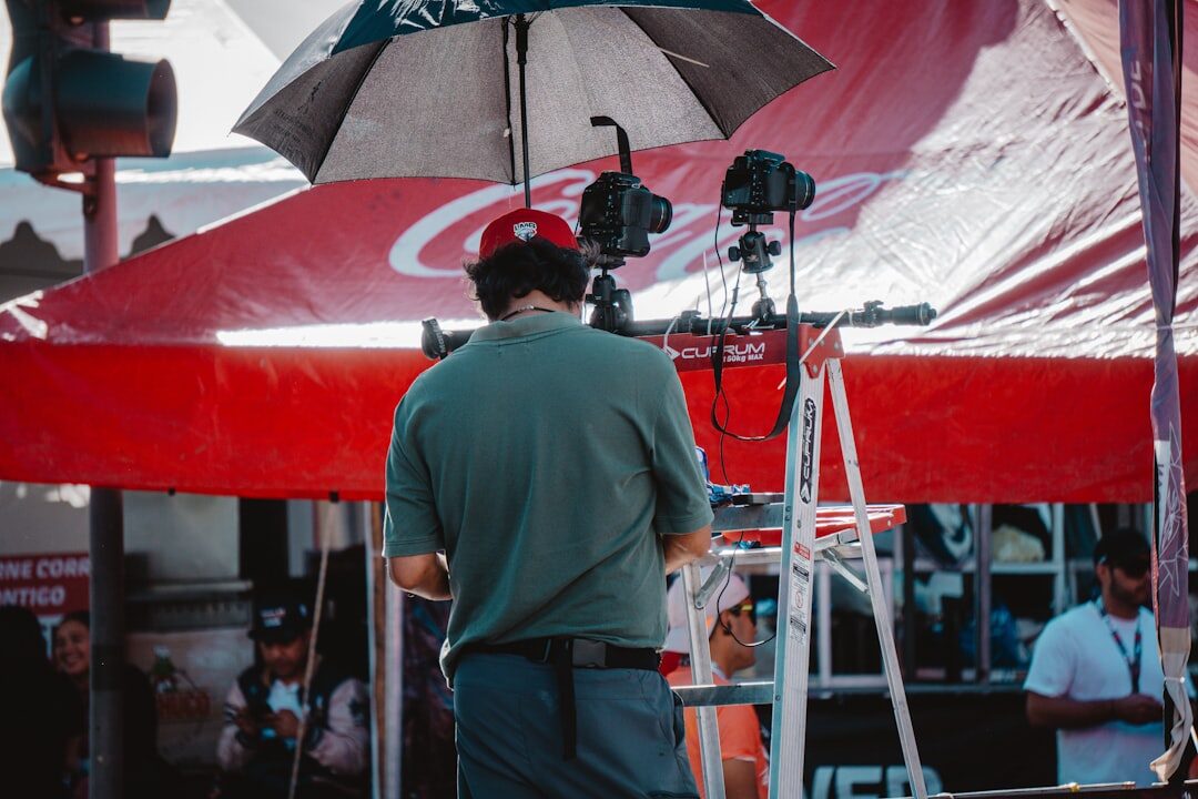Broadcast camera operator filming a live outdoor event