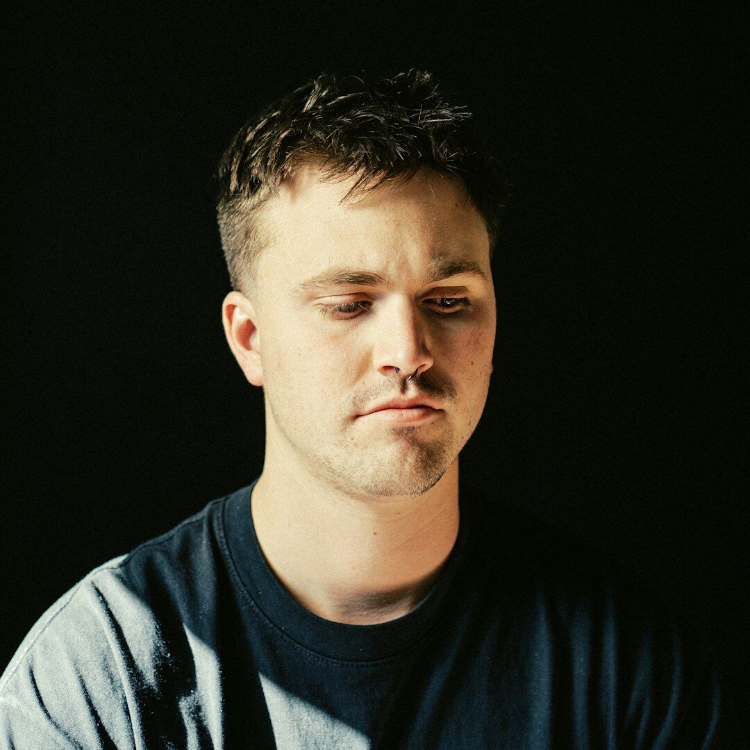 Studio portrait of a man with short hair and stubble