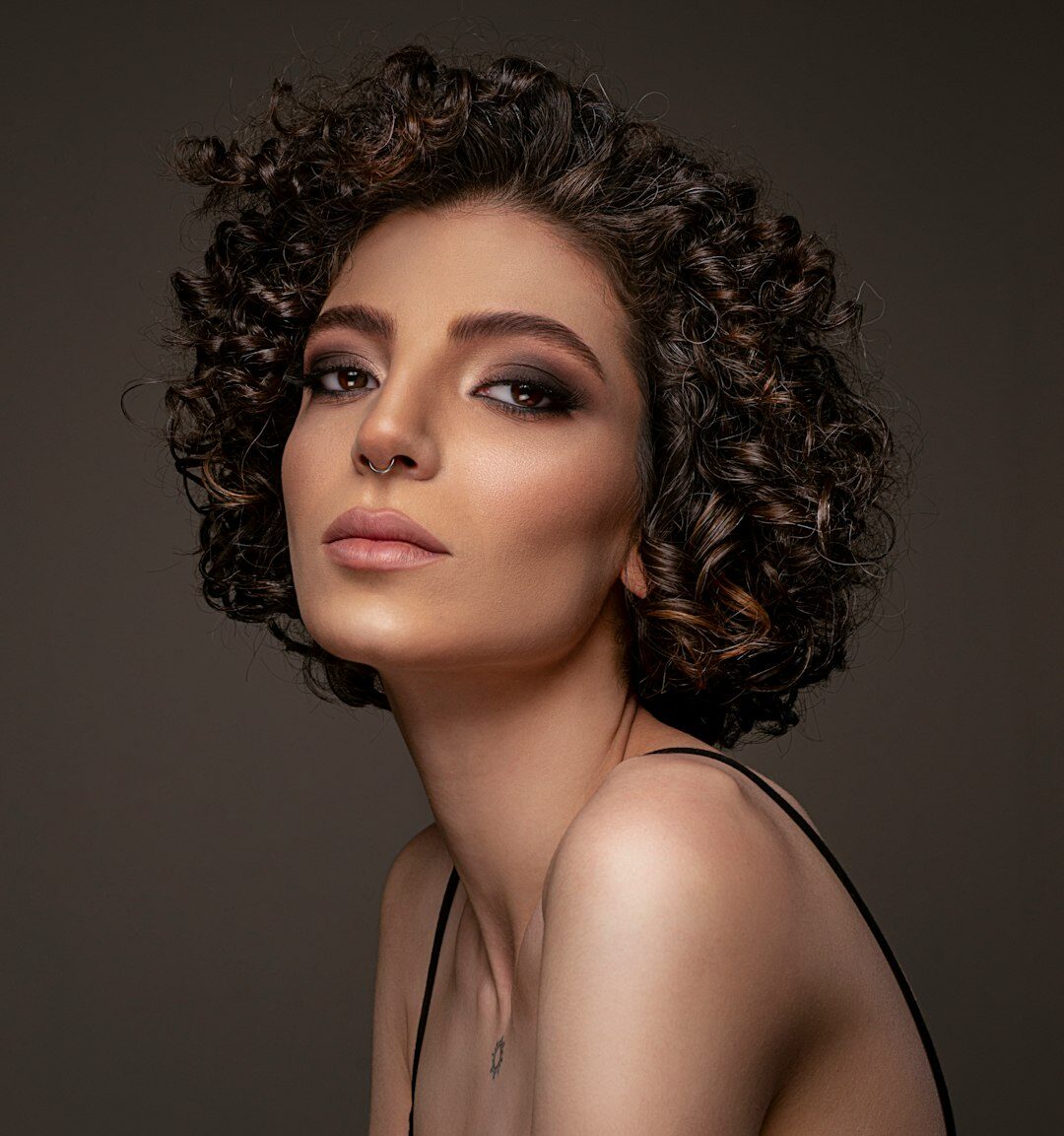 Studio portrait of a young woman with curly hair
